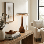 Walnut wood table lamp glowing warmly in a calm interior