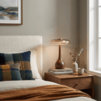 Curved wood table lamp with amber shade in a styled room