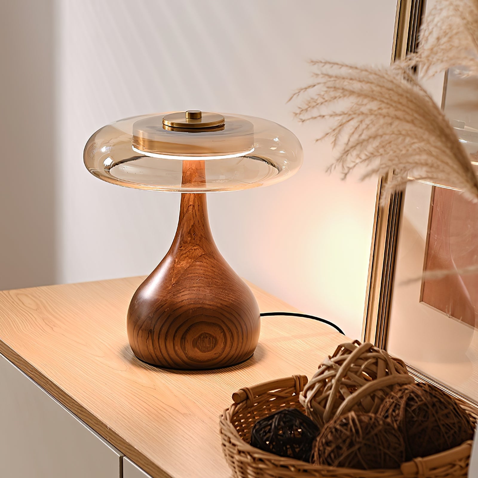 Amber glass table lamp lit gently beside a comfortable seat