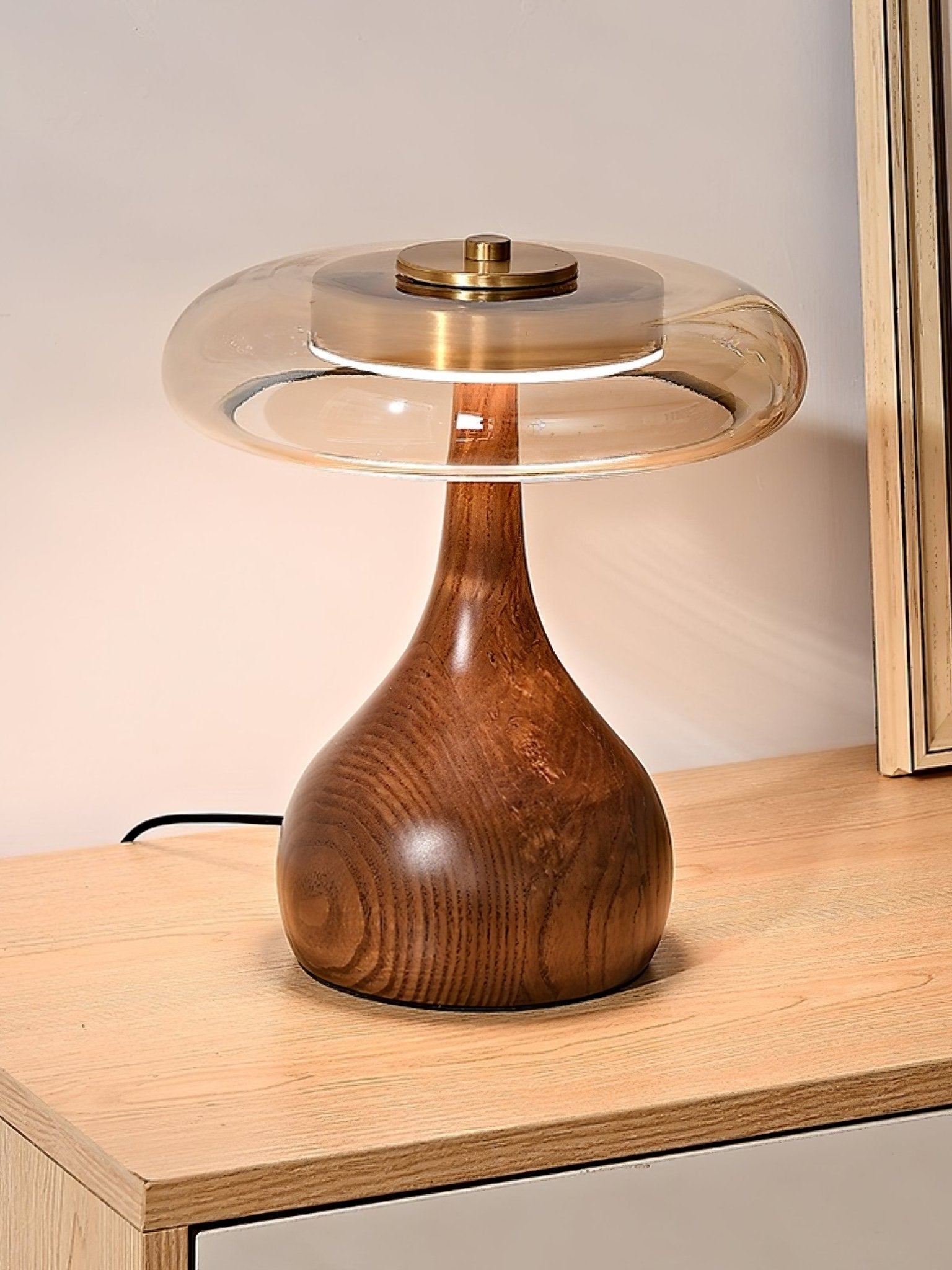 Amber glass table lamp styled on a wooden console table