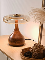 Curved wood table lamp with amber shade close-up detail