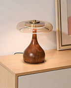 Curved wood base table lamp with amber shade in warm tones