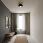 Sculptural stacked ceiling light glowing softly above a room