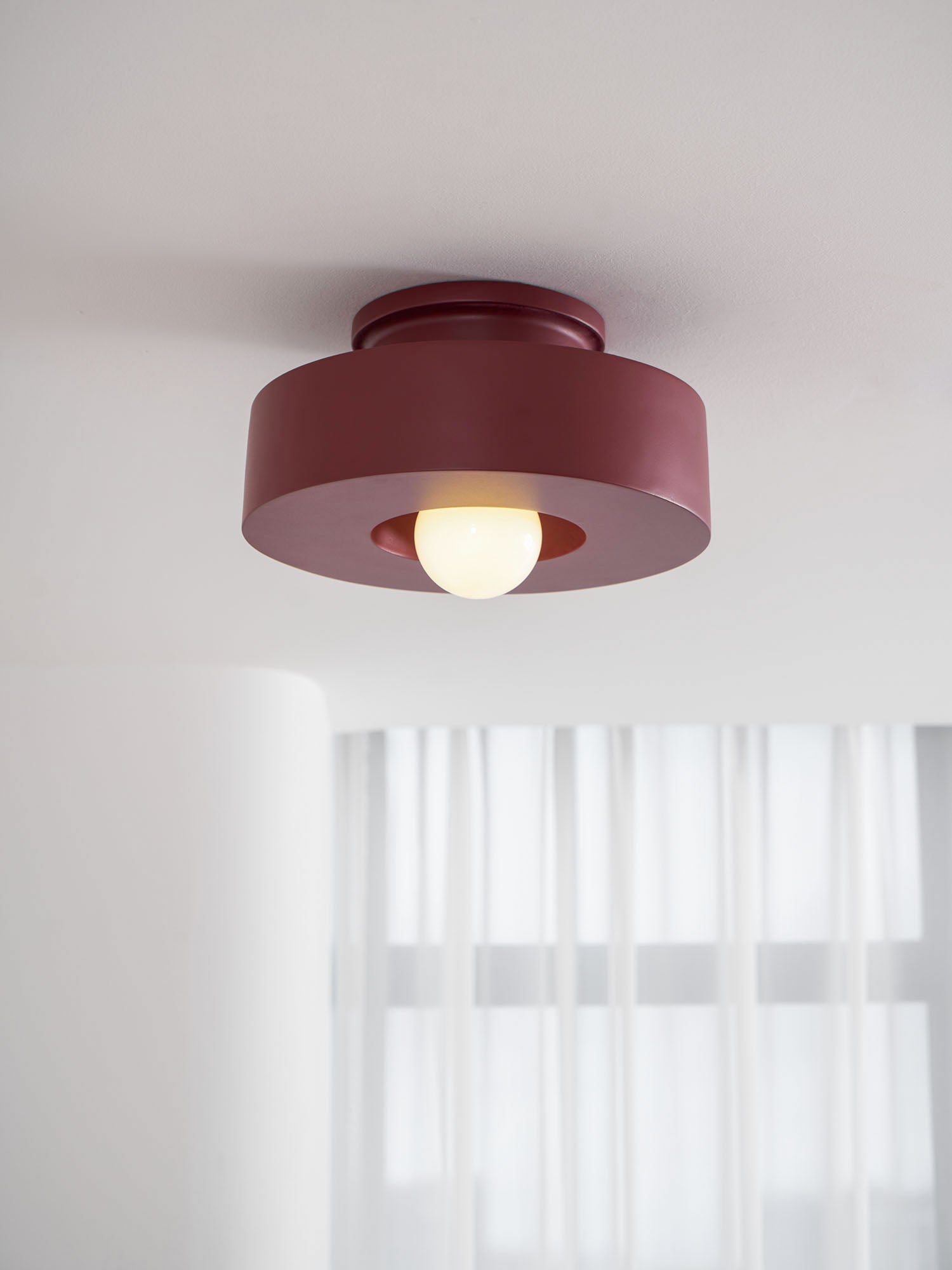 Sculptural resin ceiling light shown across colour choices