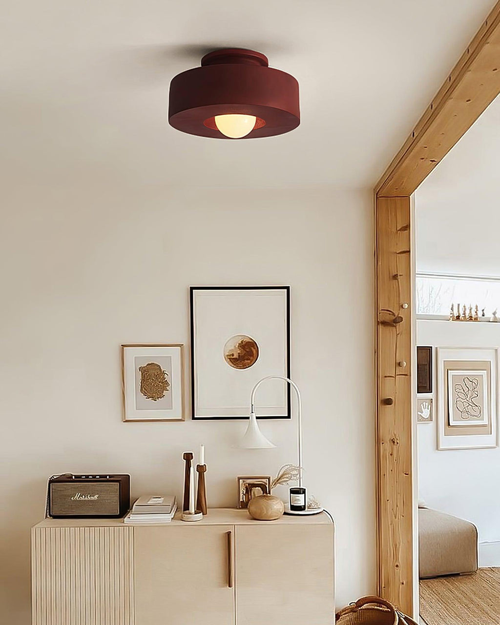 Stacked cylinder ceiling light viewed against a neutral wall