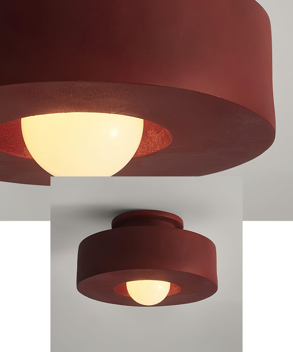 Stacked cylinder ceiling light glowing in a warm interior