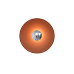 The chrome centre of this terracotta Clérachic wall light reflects a soft highlight, shown on a white backdrop.