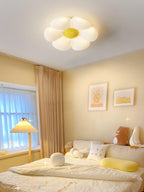Petal ceiling light lit warmly above a small dining space