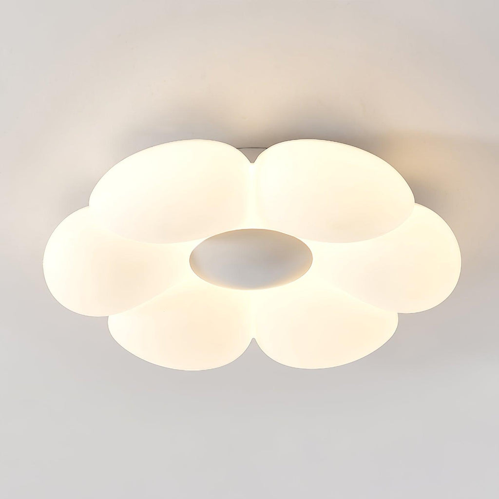 Six-petal flower ceiling light glowing softly above a styled room