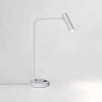 Studio shot of this white Clérachic table lamp, unlit, its cord trailing from the base.