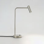 Angled studio view of this sand nickel Clérachic table lamp, unlit, head turned toward the light.