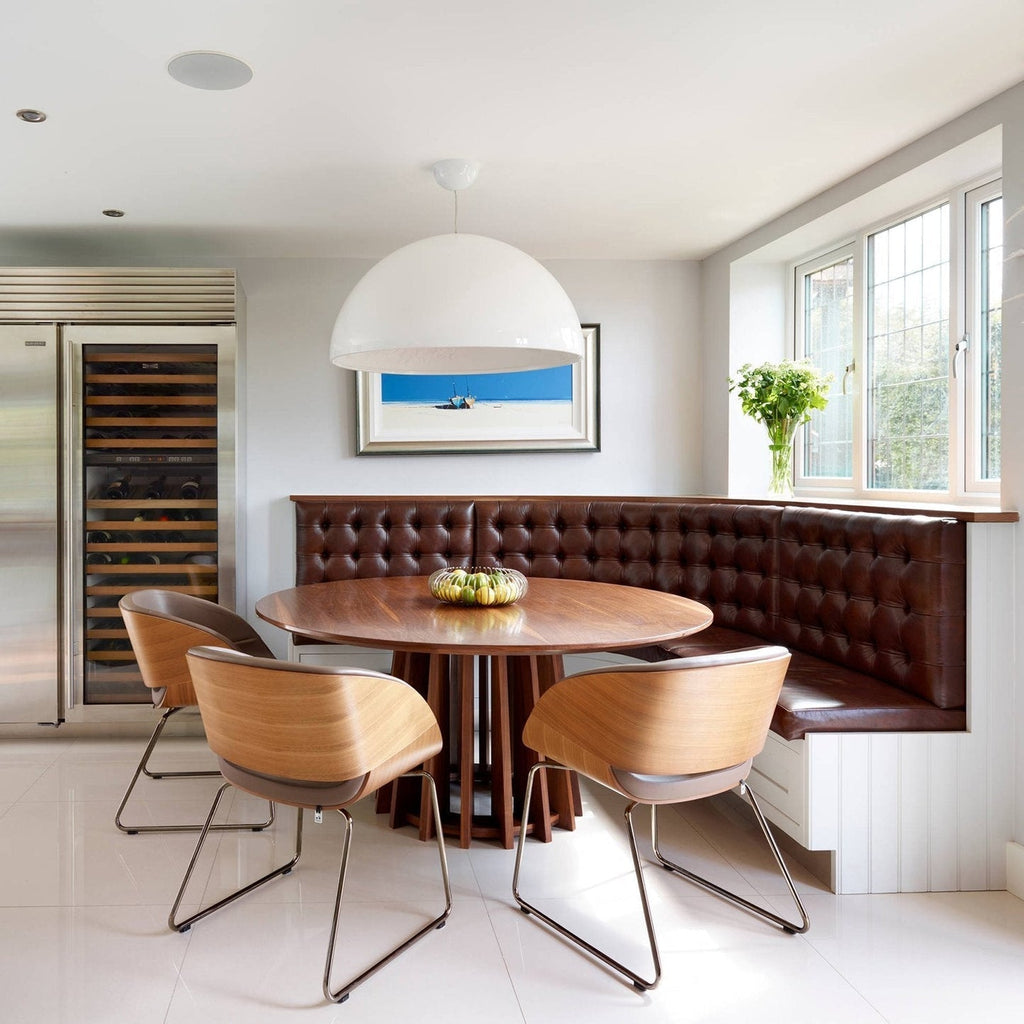 Hemisphere pendant light with smooth diffuser over a table