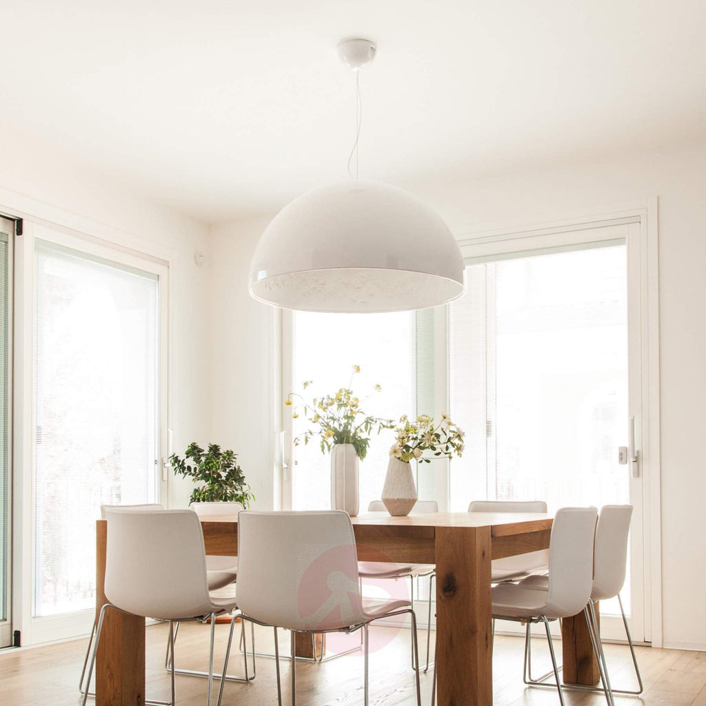 Hemisphere pendant light hanging over a table with soft downlight