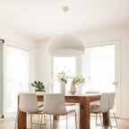 Hemisphere pendant light hanging over a table with soft downlight