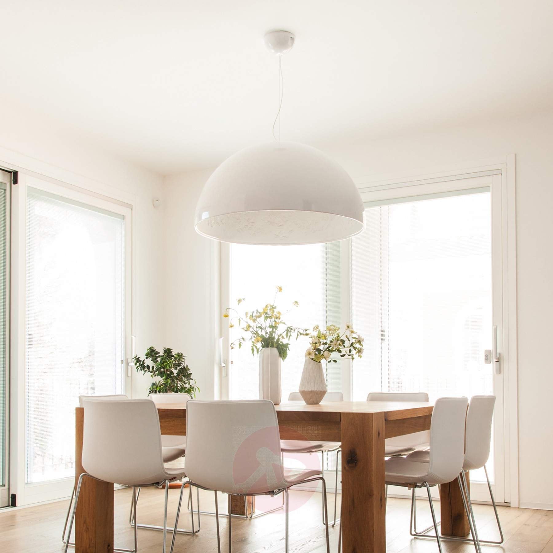 Hemisphere pendant light hanging over a table with soft downlight