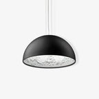 Hemisphere pendant light hanging low over a wood table