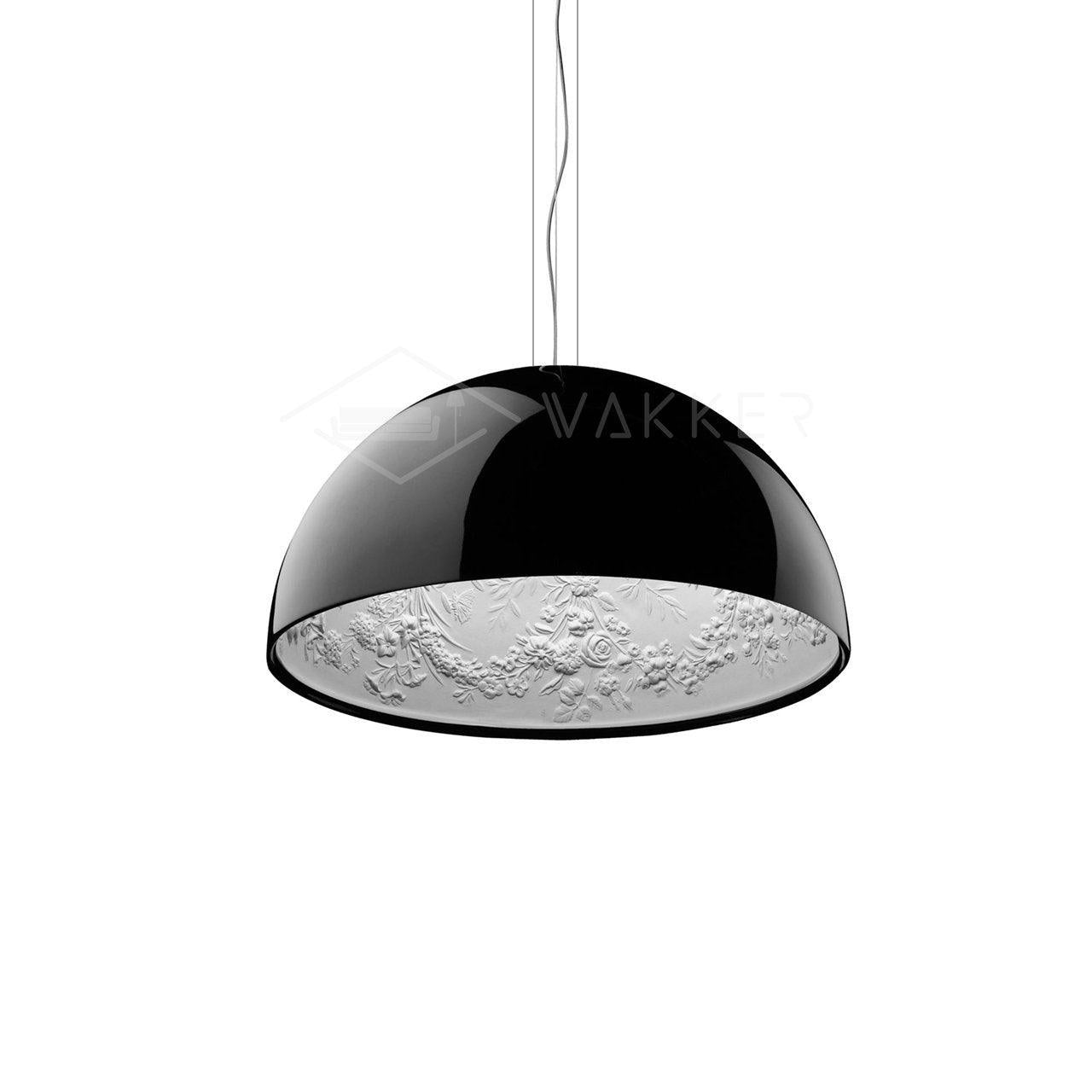 Hemisphere pendant light hanging over a table with a warm glow