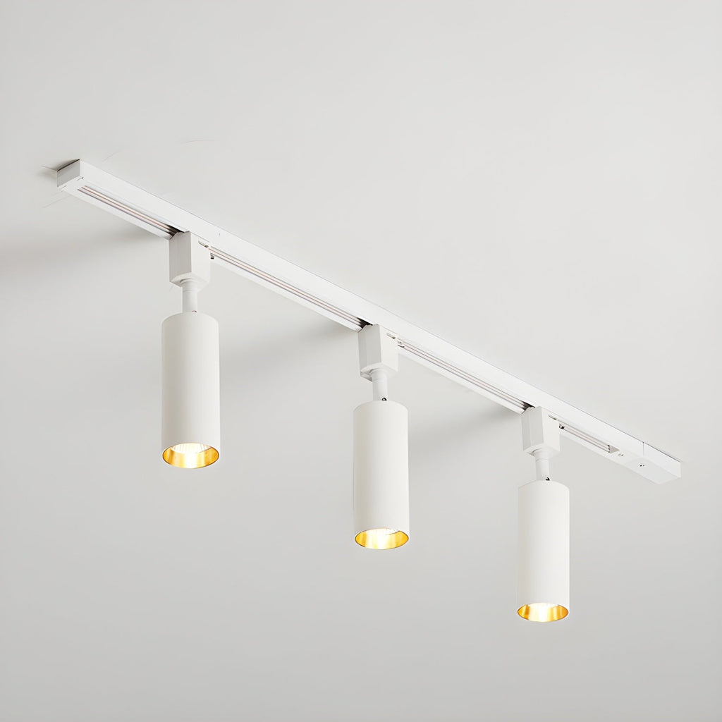 Track light with aluminium cylinders lighting a display area
