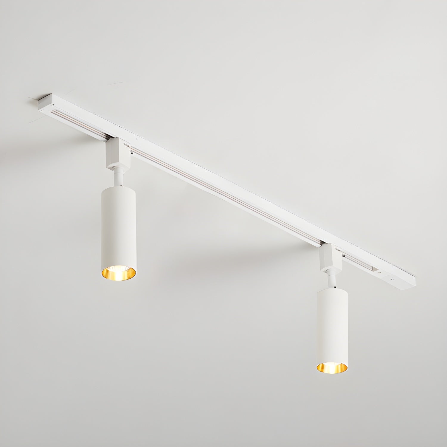 White track light with slim cylinder heads along a rail