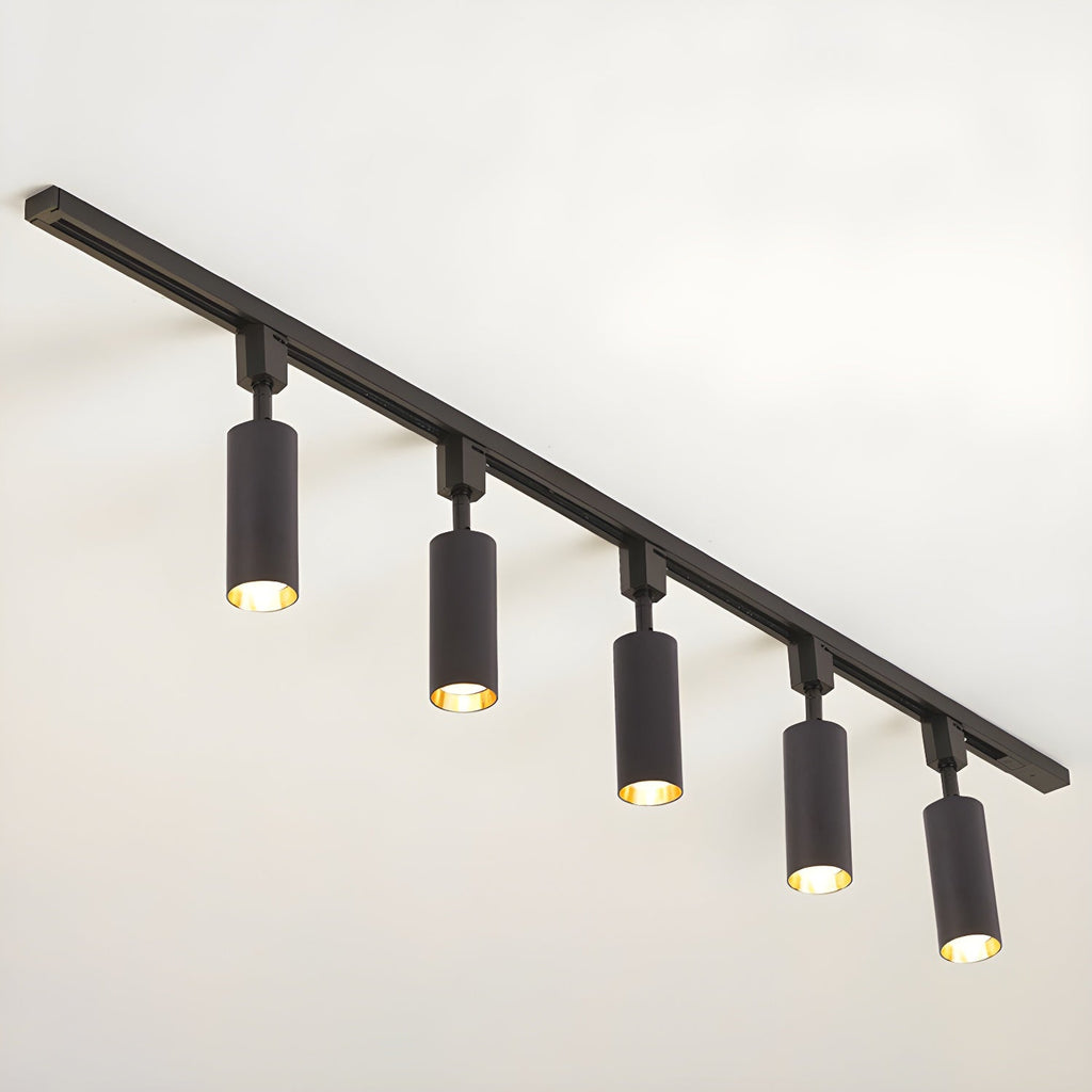 Track light cylinders casting tight beams in a styled room