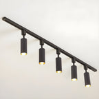 Track light cylinders casting tight beams in a styled room