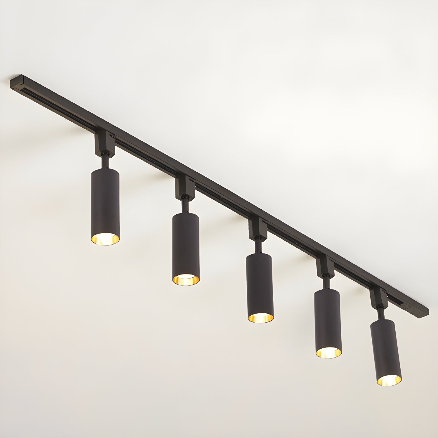 Track light cylinders casting tight beams in a styled room