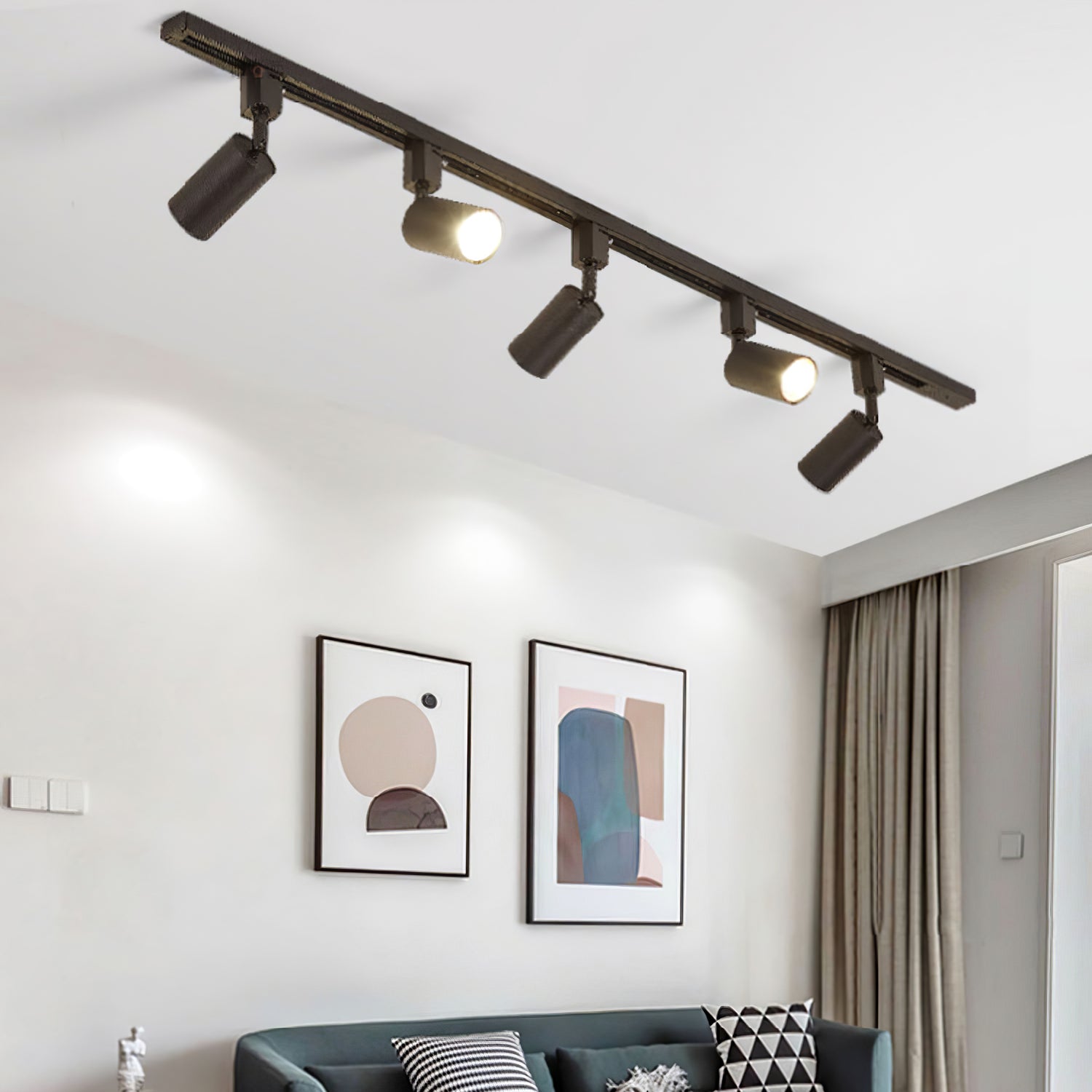 Track light cylinders casting focused light on a wall