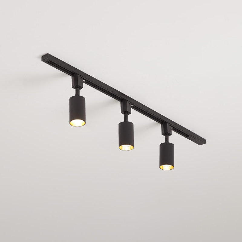 Track light spotlights casting focused beams onto a shelf