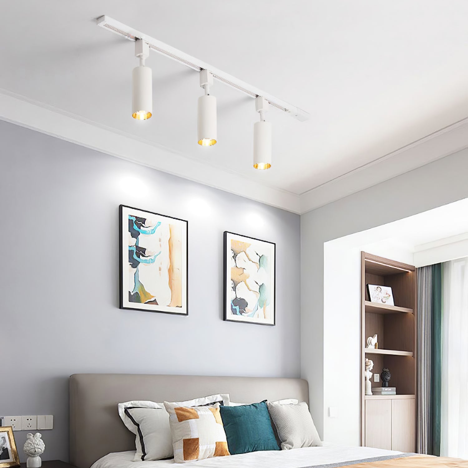 Track light with slim cylinders highlighting shelving units