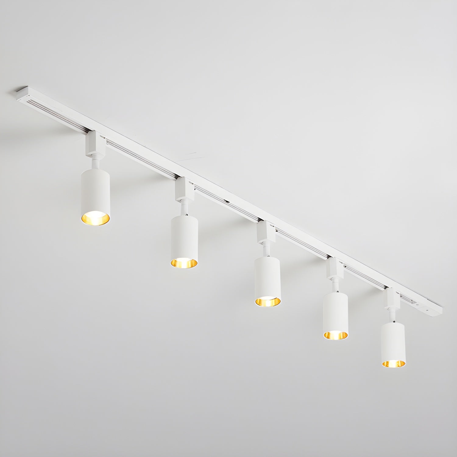 White track light with adjustable cylinder heads on a rail