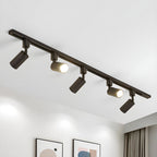 Track light with aluminium cylinder heads on a sleek rail