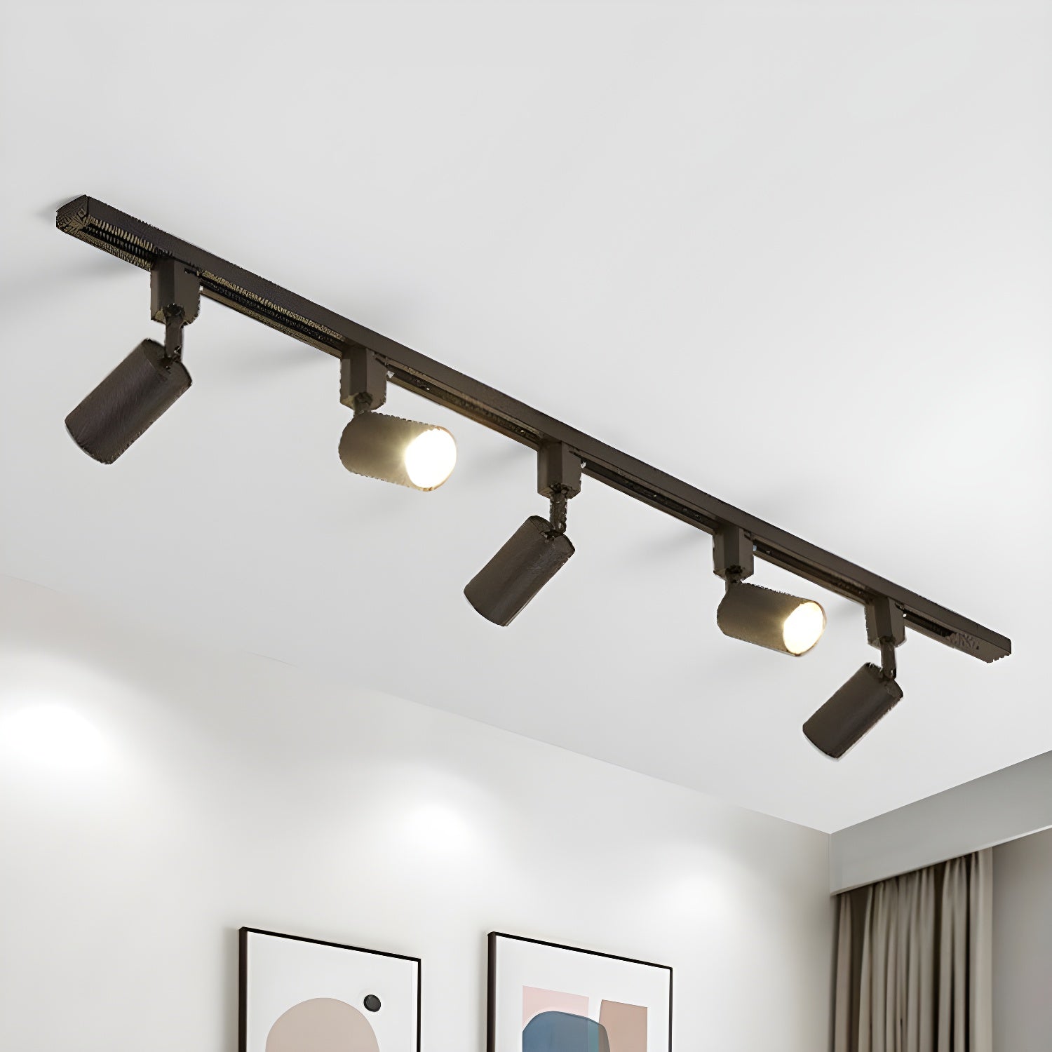 Track light with aluminium cylinder heads on a sleek rail