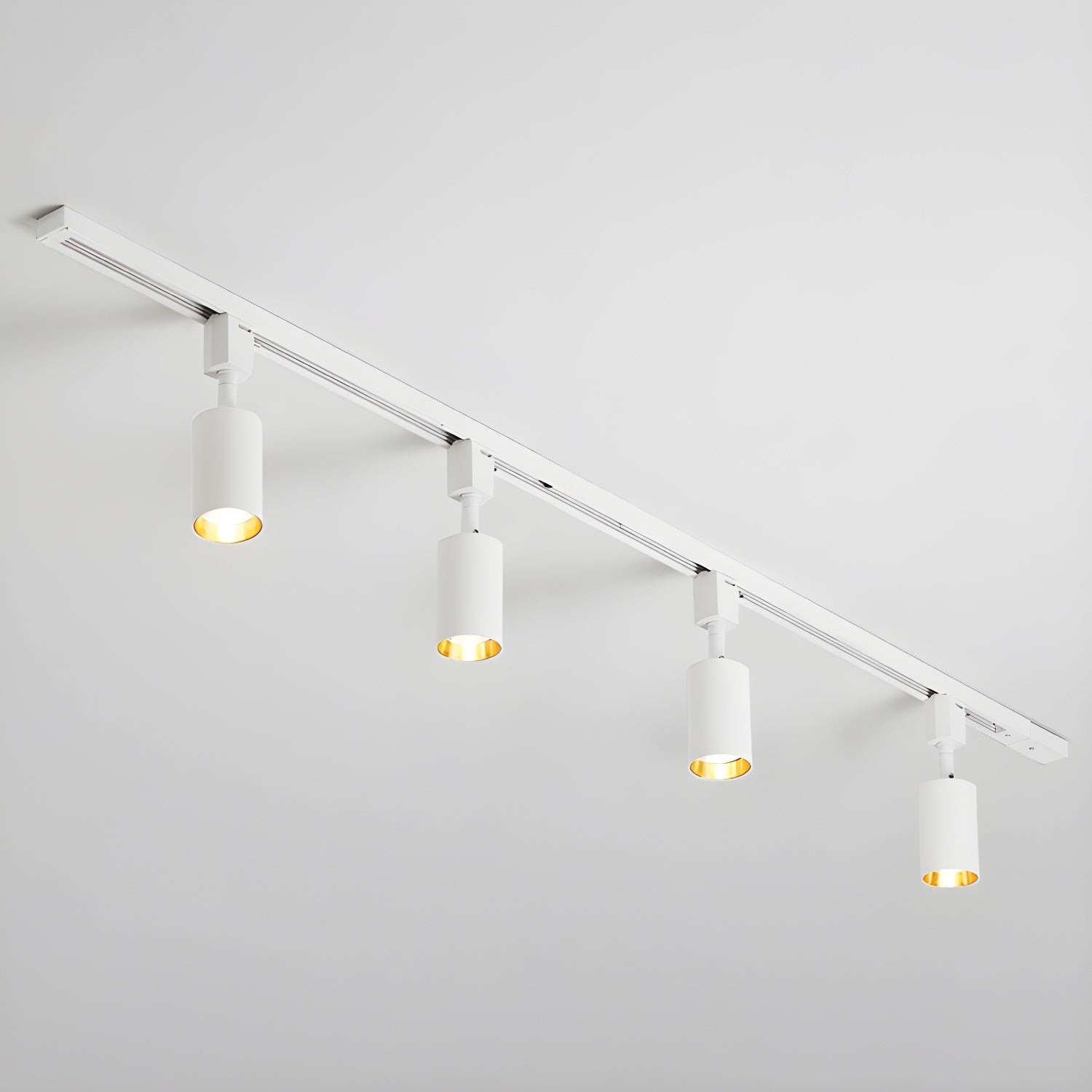 Cylinder track light shown with focused warm accent beams