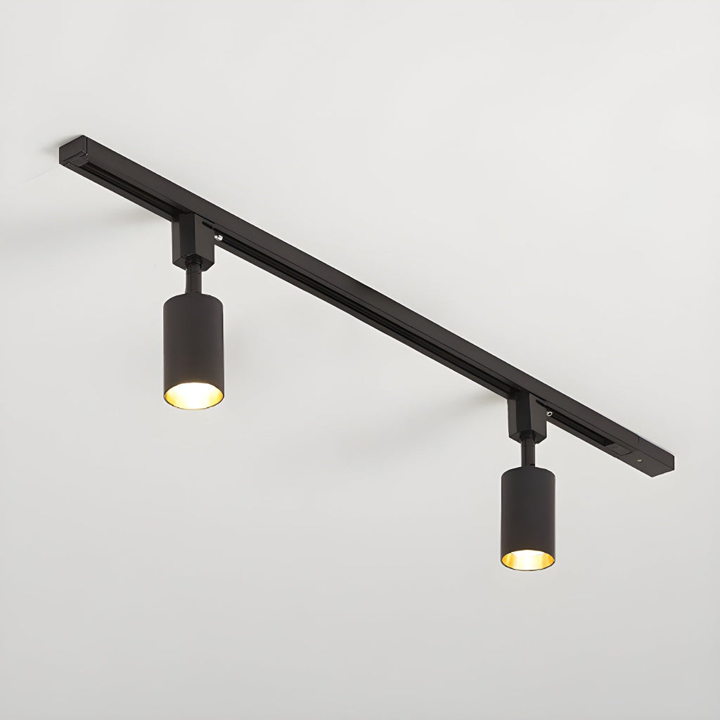 Cylinder track light with aluminium spotlights mounted on a ceiling