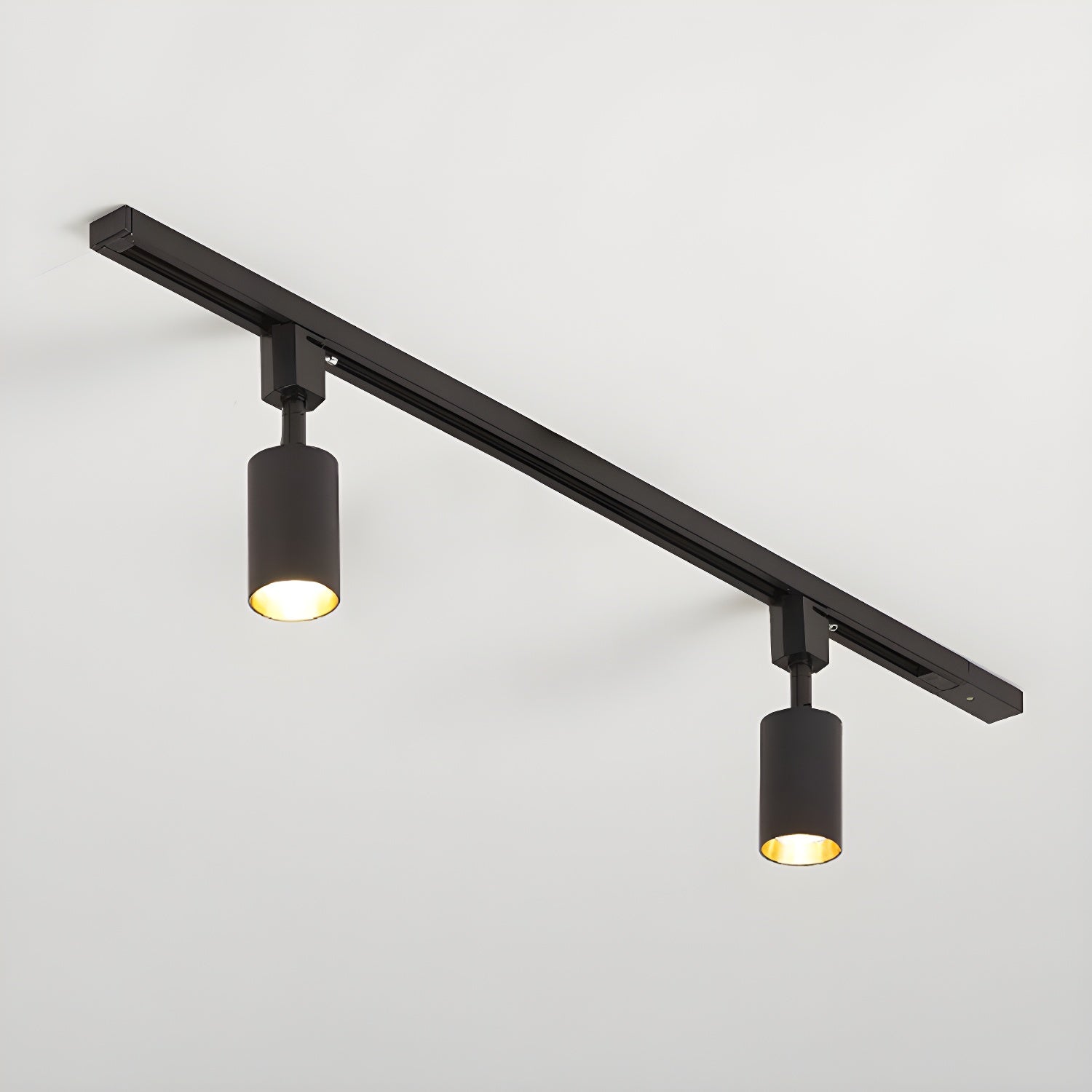 Cylinder track light with aluminium spotlights mounted on a ceiling