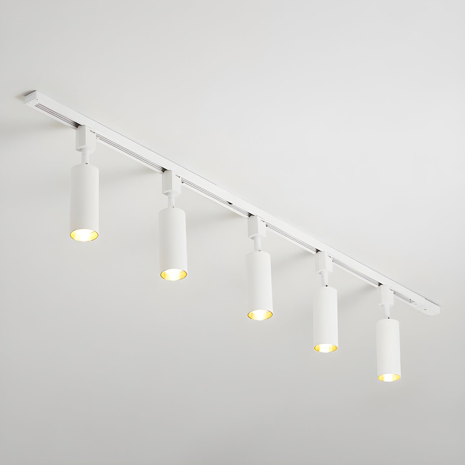 Aluminium cylinder spotlights on a ceiling track close-up