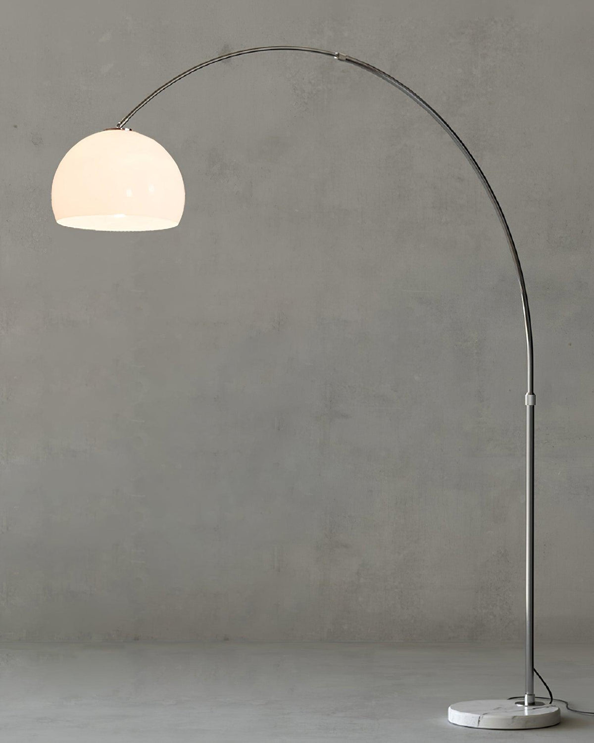 Clérachic arc floor lamp with a white dome shade shown full-length against a plain grey studio background.