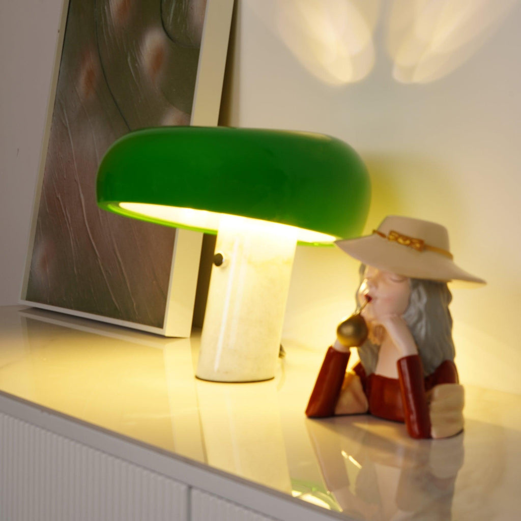 Marble table lamp with glazed metal shade on a desk