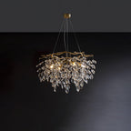 Round brass chandelier on dark grey, clear crystal petals falling in tiers below curved arms.