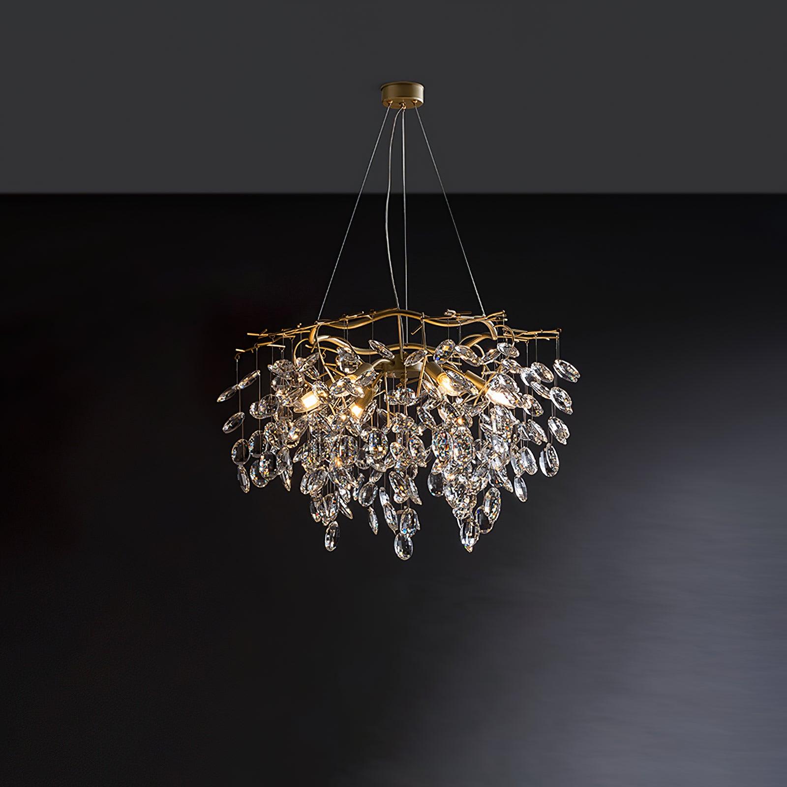 Round brass chandelier on dark grey, clear crystal petals falling in tiers below curved arms.