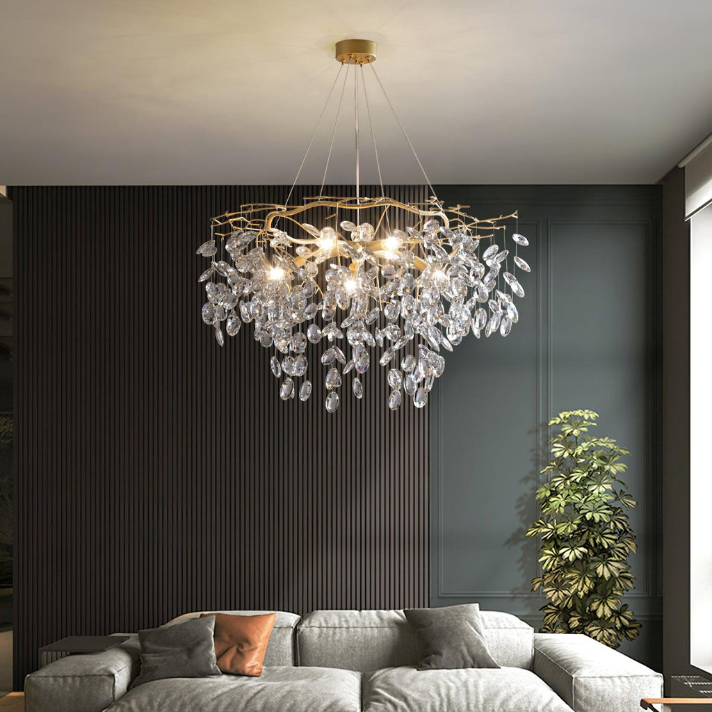 Lit above a grey sectional sofa against dark slatted panelling, a tall plant to the right.