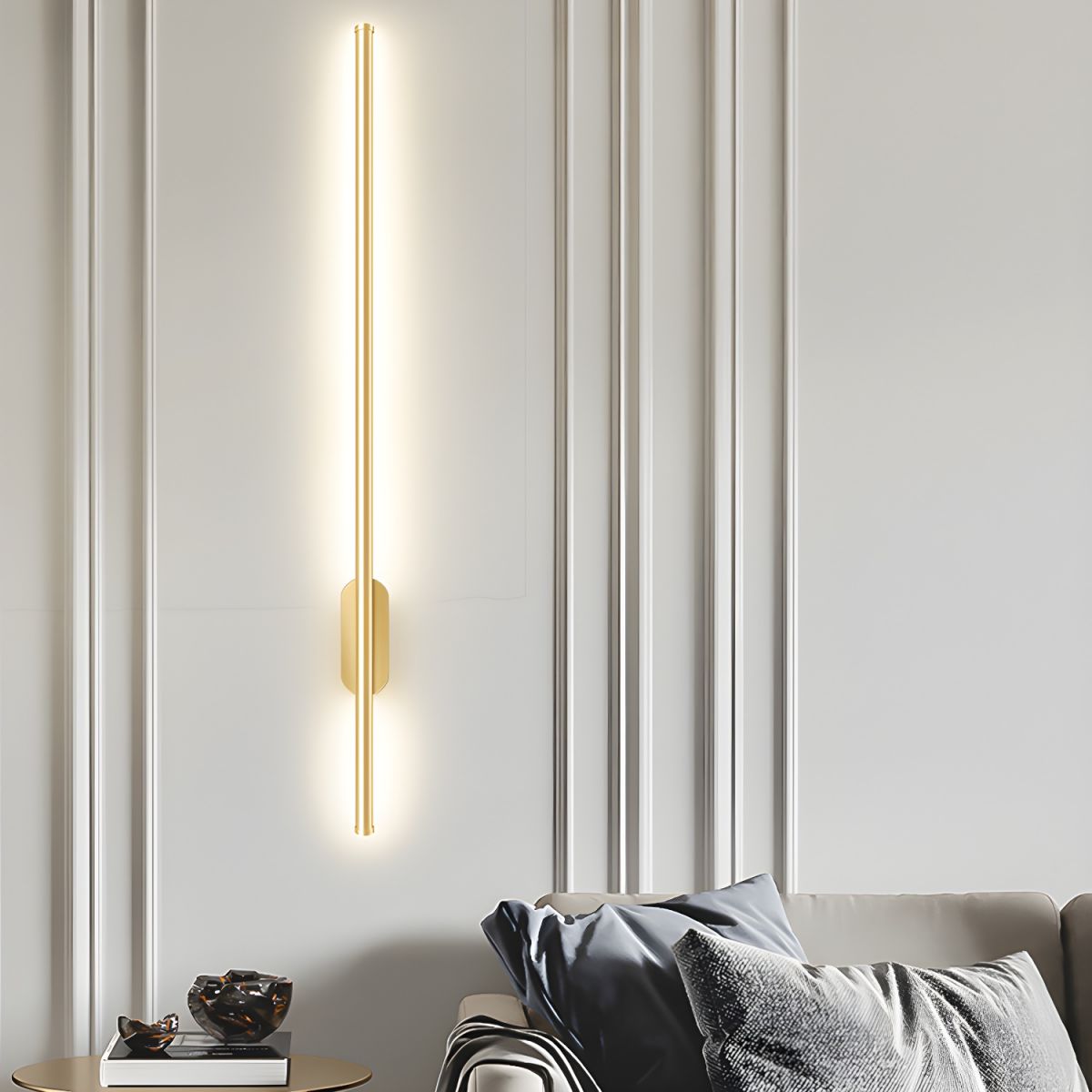 Linear wall sconce throwing soft warm light over a sideboard