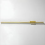 Linear LED wall sconce casting an even warm glow on plaster