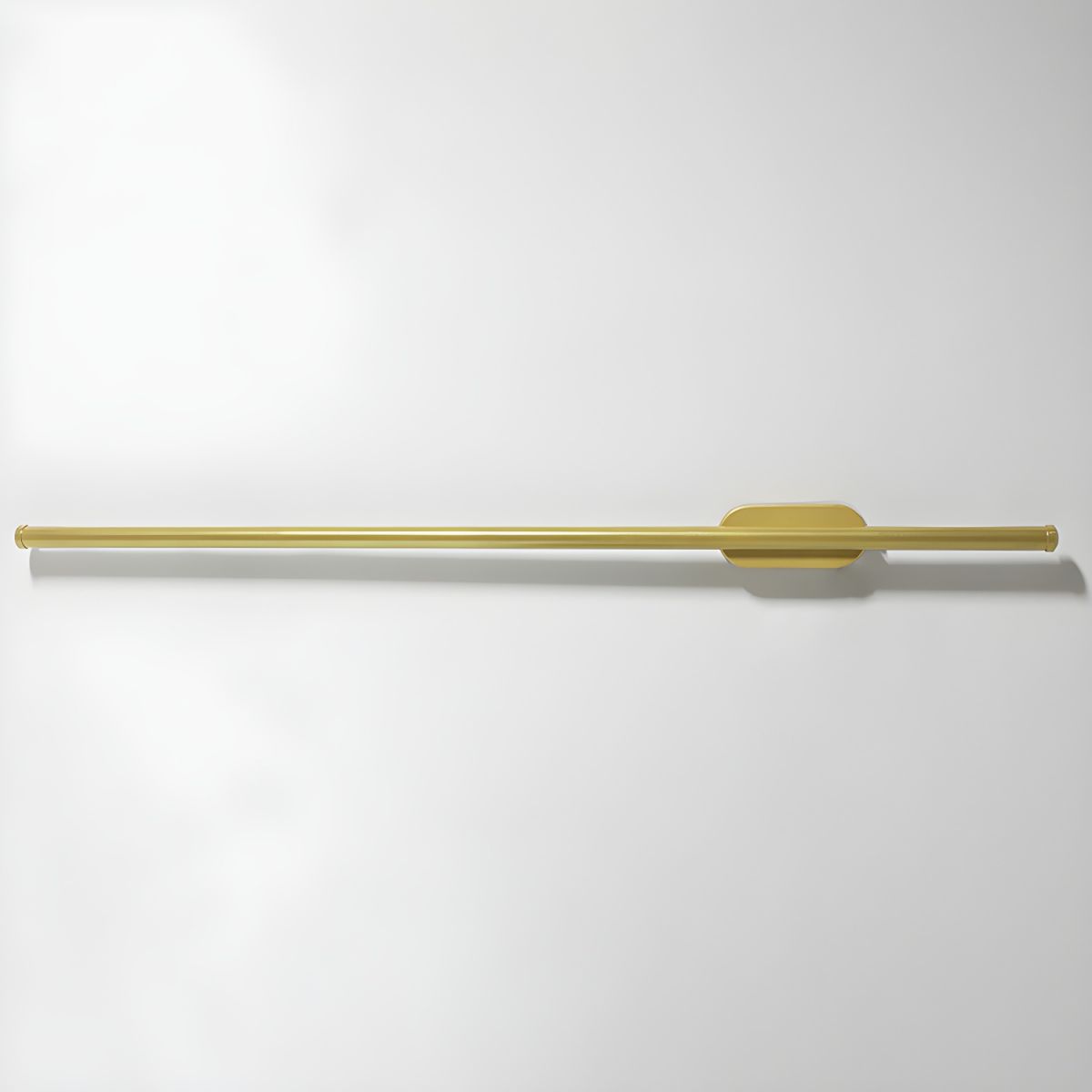 Linear LED wall sconce casting an even warm glow on plaster