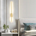 Slim linear wall sconce mounted beside a contemporary doorway
