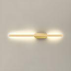 Gold linear wall sconce throwing soft warm light across plaster