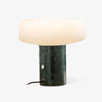 Green marble Clérachic table lamp shown alone on white, its power cord and round switch visible at the base.