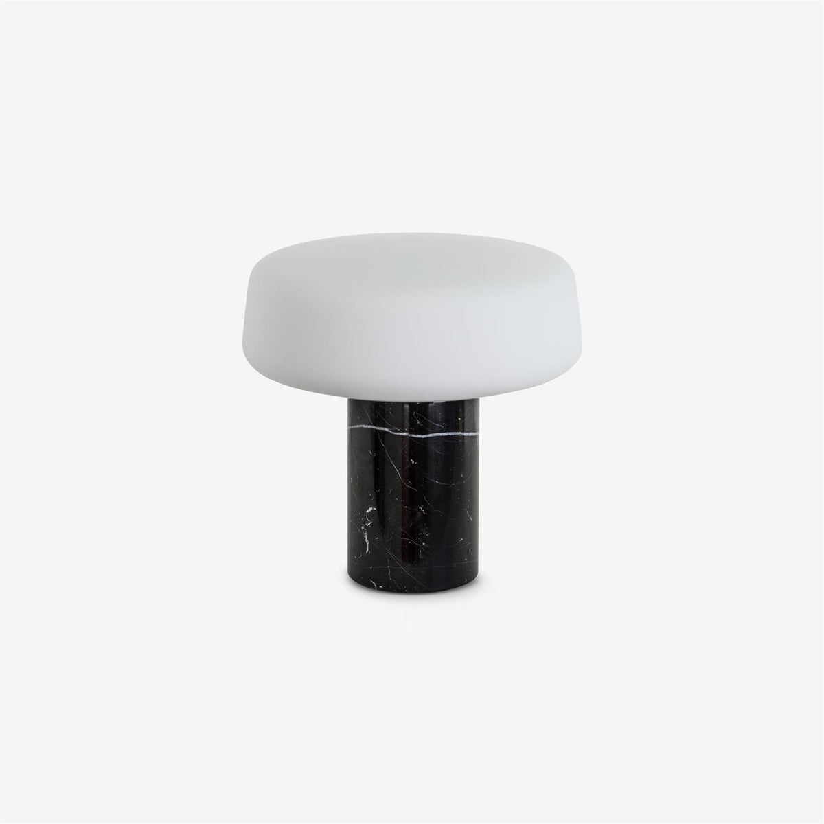 Black marble Clérachic table lamp with its frosted glass shade shown unlit against a plain grey studio background.