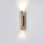 Off-centre in the studio frame, this Clérachic wall light glows lit against grey.