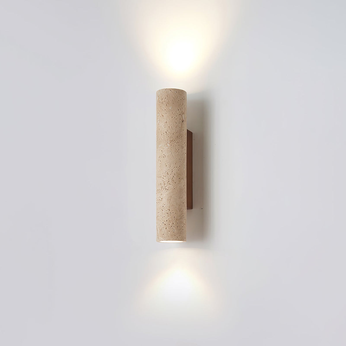 Off-centre in the studio frame, this Clérachic wall light glows lit against grey.